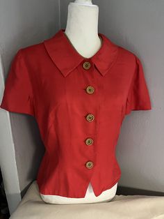 Name: Vintage Short Sleeved Red Blouse  Brand: Donna Morgan Size: 8 Measurements:22 " L 21" W Fabric: 100% silk  *Note: black mark on sleeve ** Red Fitted Top For Formal Occasions, Red Collar Blouse For Work, Silk Short Sleeve Shirt For Formal Occasions, Formal Short Sleeve Silk Shirt, Silk Semi-formal Top With Button Closure, Silk Office Top With Collar, Semi-formal Silk Top With Button Closure, Office Silk Top With Collar, Red Semi-formal Button-up Top