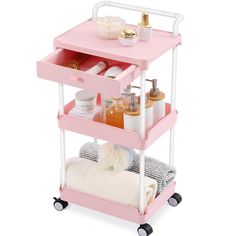 a pink and white cart with two shelves filled with cosmetics, toiletries and other items