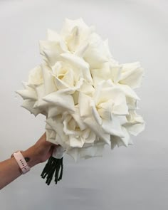 a person holding a bouquet of white flowers