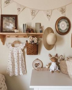 there is a shelf with hats on it and pictures hanging from the wall behind it