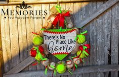 there's no place like home wreath hanging on the side of a wooden fence