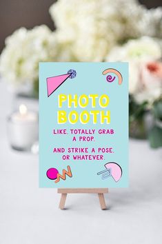 a sign that says photo booth like totally grab and strike a pose or whatever on it