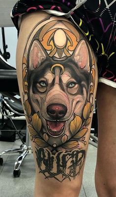 a woman with a tattoo on her leg and dog's head in the middle