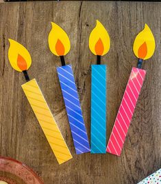 birthday candles made out of construction paper on a table