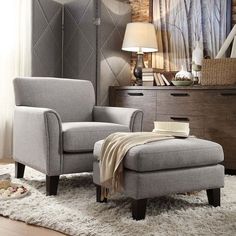 a chair and ottoman in a room with brick wall, rugs and flooring