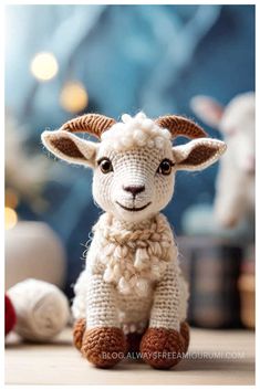 a small stuffed sheep sitting on top of a table