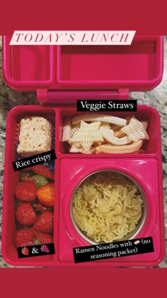 a pink lunch box filled with veggies, strawberries and rice krispy treats