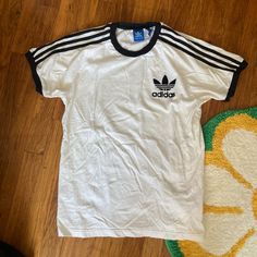 White And Black Adidas Short-Sleeve T-Shirt With The Three Stripes Down The Sleeve. Size M. 100% Cotton Very Clean, Never Worn By Me By It Was Too Small. Approx Laying Flat: -Pit To Pit: 19.25” -Neck Point To Sleeve Edge: 12” -Base Of Neck To Bottom Of Hem: 22” Final Sale.