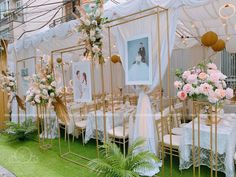 the tables are set up with white linens and pink flowers