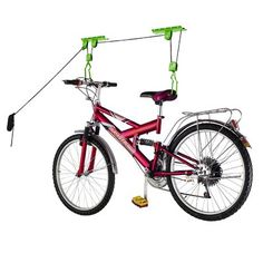 a red bicycle with two green handles attached to it