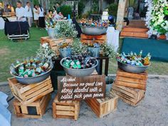 several wooden crates with beer bottles in them on display at an outdoor event or gathering