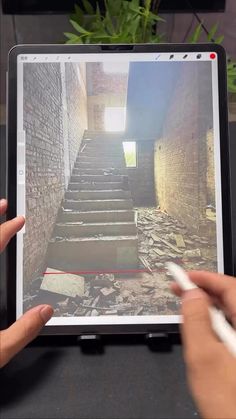 someone is using their tablet to take a photo of the stairs in an abandoned building