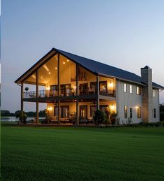 a large house sitting on top of a lush green field