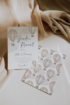 the wedding stationery is laid out on top of the bed