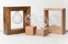 three glass globes in wooden frames on a white background