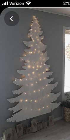 a white christmas tree with lights on it