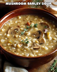 mushroom barley soup in a wooden bowl with herbs