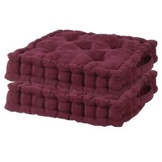 two burgundy dog beds stacked on top of each other in front of a white background