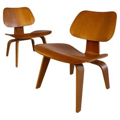 two wooden chairs sitting side by side