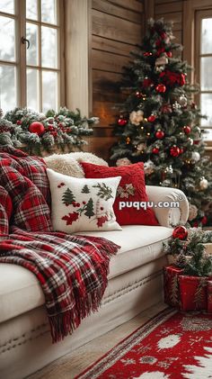 a living room decorated for christmas with red and white decorations on the couch, plaid throw pillows and stockings