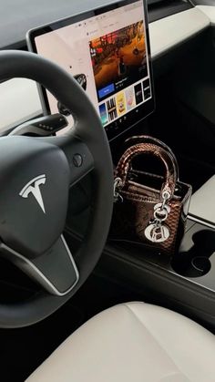 the interior of a car with a laptop and purse