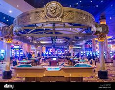 the inside of a casino with tables and slot machines