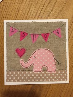 an elephant with pink hearts and bunting on it