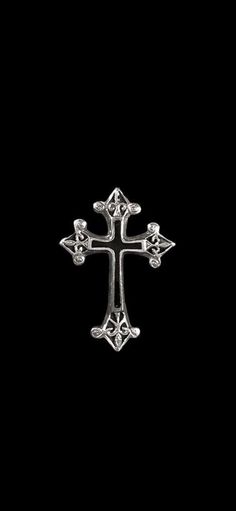 an ornate cross on a black background