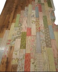 the floor is covered with many different types of fabric and wood planks that are laid on top of each other