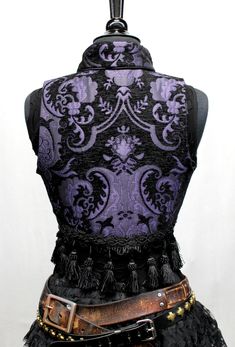 A beautiful bellydancer/burlesque style vest from the old country. A short vest with a stand-up collar in vintage european style, made in lush purple and black tapestry fabric with black satin lining inside. Exquisite black satin piping trim all over. Front fastens back with ornate metal medieval lion buttons or can be undone and crossed over worn double-breasted fashion. Elaborate tassel trim at the bottom. Great for any bohemian affair. Comes in sizes Small-3X. Splendid! Measurements: Small: C Purple Pirate, Black Tapestry, Style Vest, Stage Outfit, Vintage European, Short Vest, Tapestry Fabric, Belly Dancers, European Vintage