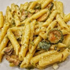 pasta with broccoli and other vegetables on a white plate