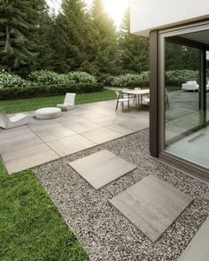 an outdoor patio area with chairs, tables and graveled walkways in the foreground