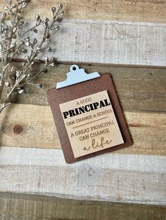 a clipboard attached to a piece of wood with the words principals written on it