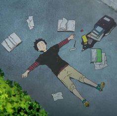 a man laying on the ground surrounded by papers and books with his arms out in the air