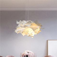 Creative cloud pendant light fashioned from delicate paper, the art decor cloud pendant light embodies a cloud-like form that imparts a light, airy ambiance. Its intricate folds contribute to a sense of depth and artistic expression, elevating this pendant lamp into a creative masterpiece. Ideal for minimalist living rooms, tranquil bedrooms, or stylish dining areas, this white lamp casts a soft, diffused glow that imbues spaces with a dreamy allure. A stunning focal point for enthusiasts of innovative design and serene beauty alike. Please note that your payment does not include customs duties, local taxes or other import charges. The order does not include bulbs. If you have any questions about our products, please contact us and we will get back to you within 24 hours. White flower pend Art Deco Pendant Light, Cloud Pendant, Modern Appartement, Creative Origami, Bedroom Pendant, Pendant Lighting Bedroom, Round Lamp, White Canopy, Art Decor Diy