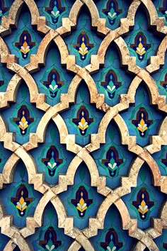 an intricately designed wall with blue and green tiles