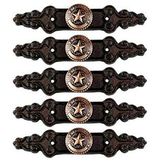 four pieces of leather and metal with stars on the center, one has a star in the middle