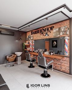 the interior of a barbershop with chairs and brick wall behind it that says barber shop