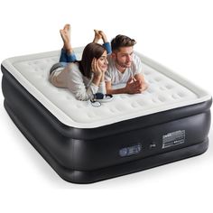 a man and woman laying on top of an inflatable mattress