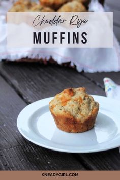 a muffin sitting on top of a white plate next to other muffins