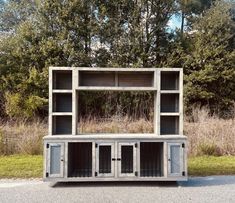 an outdoor entertainment center made out of pallets with doors and windows on each side