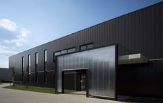 an industrial building with black walls and doors