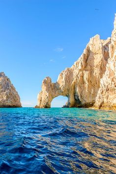 an ocean view with rocks and blue water