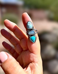 I like to call this the "ocean wave" ring both because of the color of these stones together and the stamping. The four small circles on the ring were handstamped by me, and look like tiny little ocean waves! The gorgeous Golden Hills turquoise stone on top, an Australian opal doublet in the middle, and Mexican turquoise stone on the bottom, come together to remind us of the cool colors of the ocean. Has a stamped split ring band. This is one stunning ring sure to make a statement! This ring can Golden Hill, Cool Colors, Main Menu, Wave Ring, Small Circle, Ocean Wave, Australian Opal, Split Ring