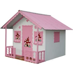 a pink and white doll house with lots of windows