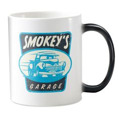 a black and white coffee mug with smokey's garage on it