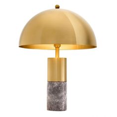 a table lamp with a marble base and a gold dome shade on the top, against a white background