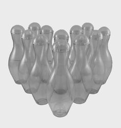 six clear glass vases sitting side by side