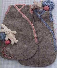 two baby sleeping bags with stuffed animals in them