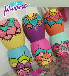 colorful painted eggs sitting on top of a table